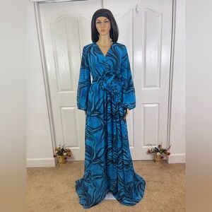 Vibrant Blue Patterned Wrap Maxi Dress with Flower Accent